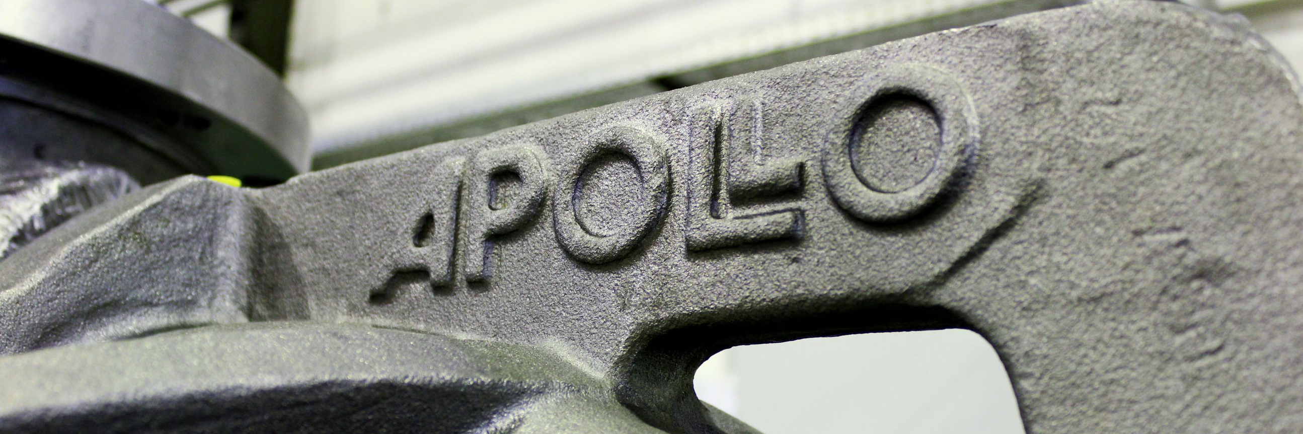 Detail of a cast pump housing with Apollo logo in the casting.