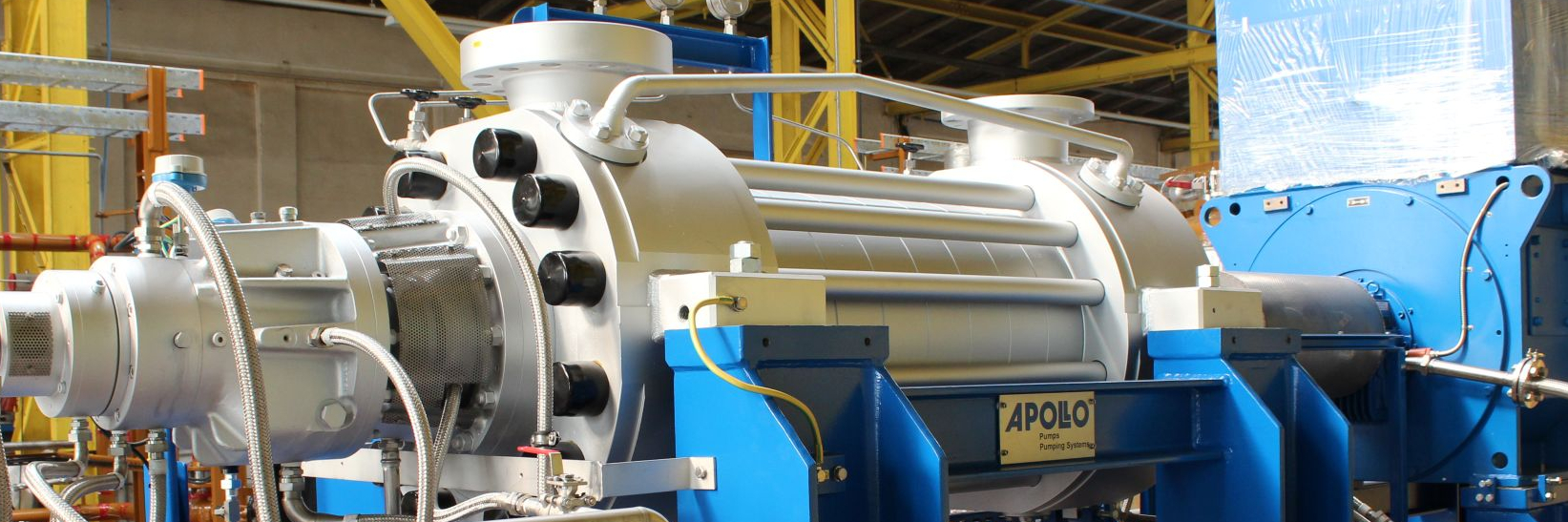 A close-up of a BB4 pump unit of the Apollo type HP with piping and lubricating oil system in the production hall.